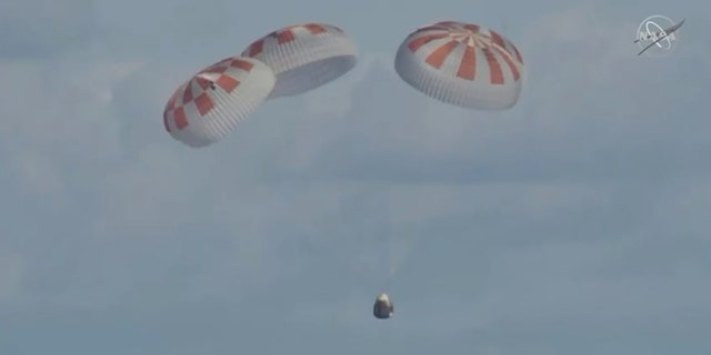 Crew Dragon deployed its four main parachutes before splashing down in the Atlantic Ocean. (NASA TV)
