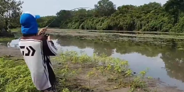 Daniel, seen here, hooked the barramundi only seconds before the crocodile reared its head.