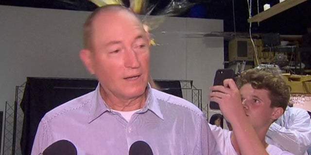 A teenager is seen breaking an egg on the head of Senator Fraser Anning on Saturday, March 16, 2019.