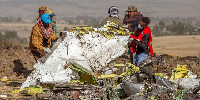 Rescuers work at the scene of an Ethiopian Airlines flight crash near Bishoftu, or Debre Zeit, south of Addis Ababa, Ethiopia, Monday, March 11, 2019. A spokesman says Ethiopian Airlines has grounded all its Boeing 737 Max 8 aircraft as a safety precaution, following the crash of one of its planes in which 157 people were killed. (AP Photo/Mulugeta Ayene)