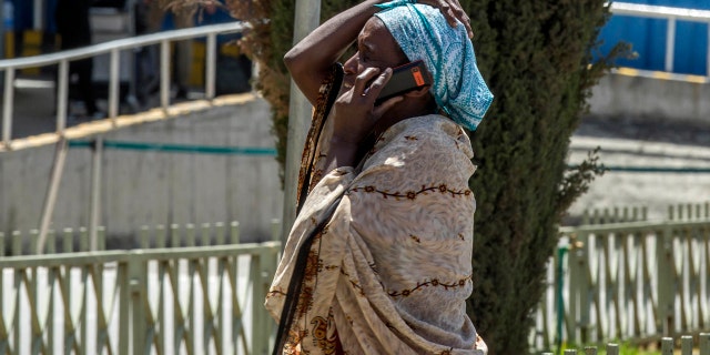 A family member of a victim involved in a plane crash talks on a mobile phone at Addis Ababa international airport Sunday, March 10, 2019.