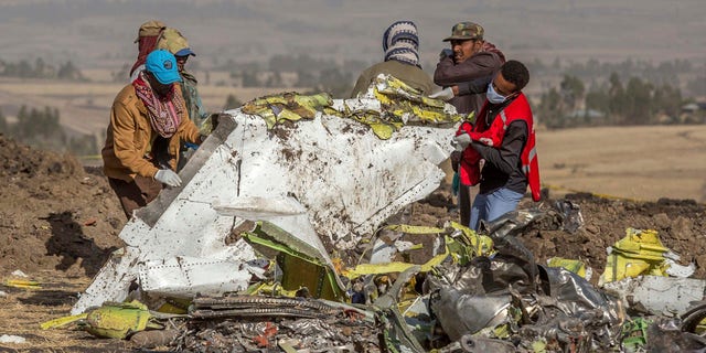 Rescuers work at the scene of an Ethiopian Airlines flight crash near Bishoftu, or Debre Zeit, south of Addis Ababa, Ethiopia, Monday, March 11, 2019.