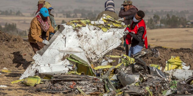 Rescuers work at the scene of an Ethiopian Airlines flight crash near Bishoftu, or Debre Zeit, south of Addis Ababa, Ethiopia, Monday, March 11, 2019.