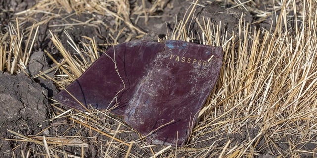 A passenger passport lies on the ground at the scene of an Ethiopian Airlines flight crash near Bishoftu, or Debre Zeit, south of Addis Ababa, Ethiopia, Monday, March 11, 2019.