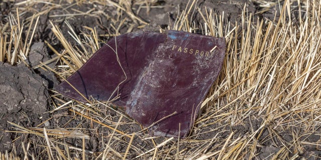 A passenger passport lies on the ground at the scene of an Ethiopian Airlines flight crash near Bishoftu, or Debre Zeit, south of Addis Ababa, Ethiopia, Monday, March 11, 2019.
