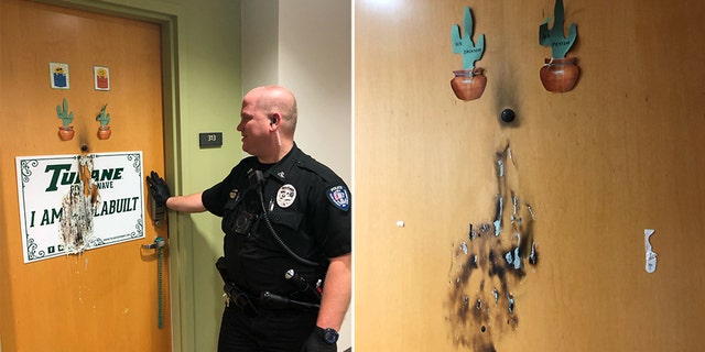 A responding officer assesses the damage after the alleged targeted arson attack on Tulane campus.