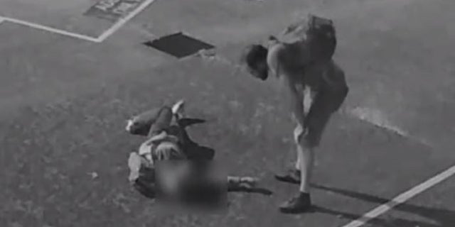A screen capture from surveillance video shows a suspect standing over an unidentified American tourist who was badly beaten in Australia, according to police.