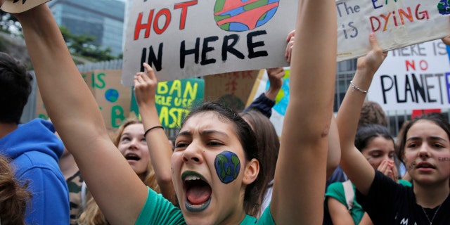 Hundreds of schoolchildren take part in a climate protest in Hong Kong, Friday. (AP Photo/Kin Cheung)