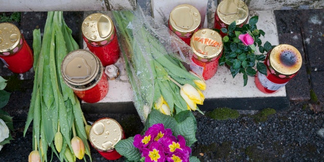 Flowers are set at a house of a doctor, who died in an explosion by a booby trap in Enkenbach-Alsenborn, Germany, Tuesday, March 5, 2019. A gardener, who was found also dead, is suspected to have set the booby trap.