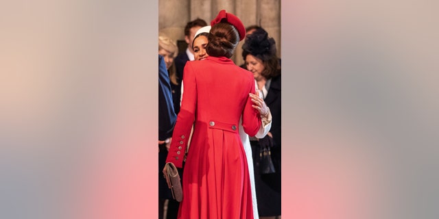 Britain's Meghan, Duchess of Sussex (L) and Britain's Catherine, Duchess of Cambridge, (R) greet each other as they attend the Commonwealth Day service at Westminster Abbey in London on March 11, 2019. — Getty