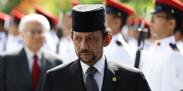 Sultan of Brunei Hassanal Bolkiah walks back after inspecting the guard of honor, accompanied by Singapore President, Tony Tan Keng Yam during the welcome ceremony at the Istana on July 5, 2017 in Singapore.
