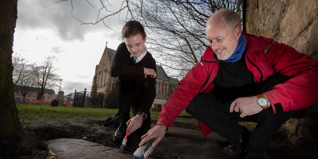 Mark McGettigan and Professor Stephen Driscoll of the University of Glasgow examine one of the rediscovered stones at Govan Old Parish Church.