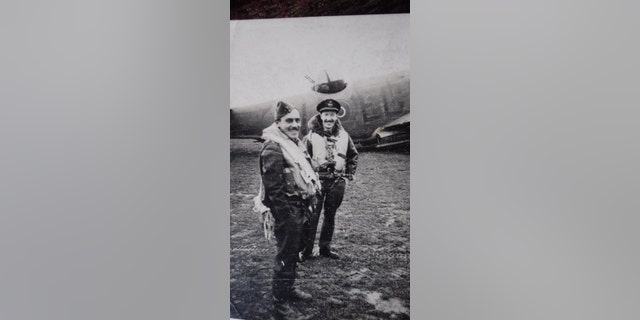 Phillips (left) and a fellow a fellow RAF officer with a Lockheed Martin Ventura aircraft in the background.(Hansons Auctioneers)
