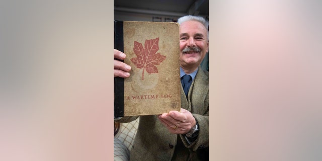 Adrian Stevenson, a militaria expert at Hansons Auctioneers, with the diary. (Hansons Auctioneers)