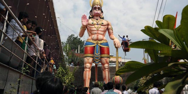 A statue of Hindu monkey-god Hanuman is washed during the birthday of Lord Hanuman in Hyderabad, India.