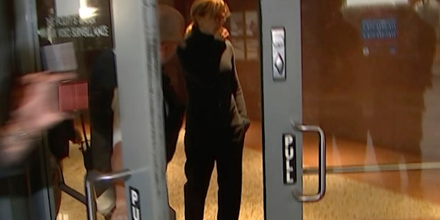 Actress Felicity Huffman walks towards the door in the lobby of a Los Angeles court after she is released on a $250,000 bond Tuesday. (AP Photo/Rick Taber)