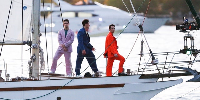 The Jonas Brothers were seen in Miami on a sailboat filming what appears to be a video for an upcoming project, having recently surprised fans with new music. 