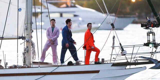 The Jonas Brothers were seen in Miami on a sailboat filming what appears to be a video for an upcoming project, having recently surprised fans with new music. 