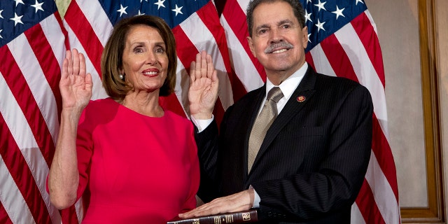 FILE - In this Jan. 3, 2019, file photo, House Speaker Nancy Pelosi of Calif., administers the House oath of office to Rep. Jose Serrano, D-N.Y., during a ceremonial swearing-in on Capitol Hill in Washington, during the opening session of the 116th Congress. Serrano, a 16-term Democrat from the South Bronx, says he has Parkinson’s Disease and will retire at the end of his term. (AP Photo/Jose Luis Magana, File)