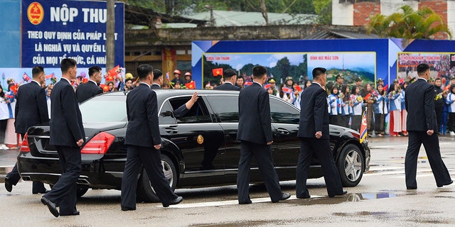North Korean leader Kim Jong Un waves from inside a car surrounded by bodyguards as he leaves the Dong Dang railway station in Dong Dang, Lang Son Province, last month. (Photo by Nhac NGUYEN / AFP) (Photo credit should read NHAC NGUYEN/AFP/Getty Images)