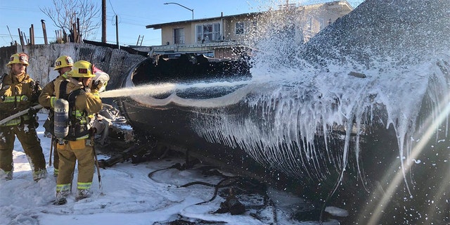 Firefighters put out the last bit of flames in the aftermath of the tanker explosion.