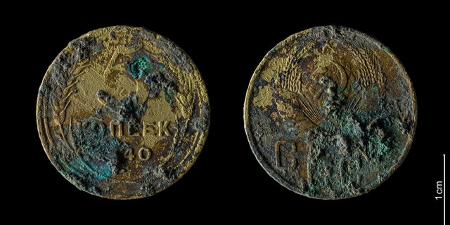 5 Soviet kopecks discovered at one of the massacre sites.