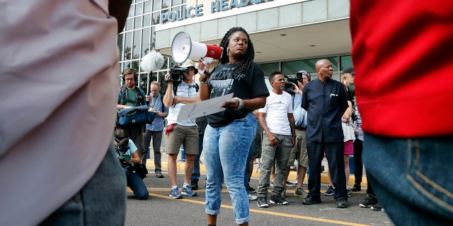 FILE - In this Sept. 17, 2017 file photo, Cori Bush speaks on a bullhorn to protesters outside the St. Louis Police Department headquarters in St. Louis. (AP Photo/Jeff Roberson, File)