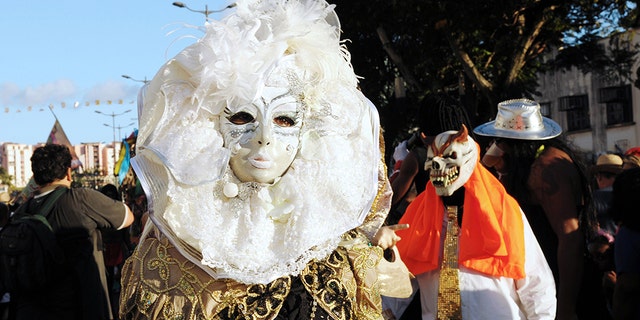 Revelers pose during the Carnival parade in the streets of Fort-de-France on the French Caribbean island of Martinique, on February 10, 2013. The Carnaval started on February 9, 2013 and will run until Ash Wednesday on February 13, 2013 when Vaval, a giant papier-mache figure symbolizing the king of the carnival, is burned. AFP PHOTO/ JEAN-MICHEL ANDRE (Photo credit should read JEAN-MICHEL ANDRE/AFP/Getty Images)