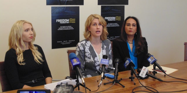 Bethany Mendez, center, along with attorney Harmeet K. Dhillon, right and Mariah Gondeiro-Watt, litigation counsel for the Freedom Foundation, at a press conference on Monday.