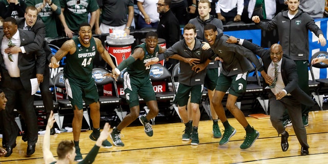 Michigan State players begin to celebrate their win over Duke at the end of the NCAA men's East Regional final college basketball game in Washington, Sunday, March 31, 2019. (AP Photo}