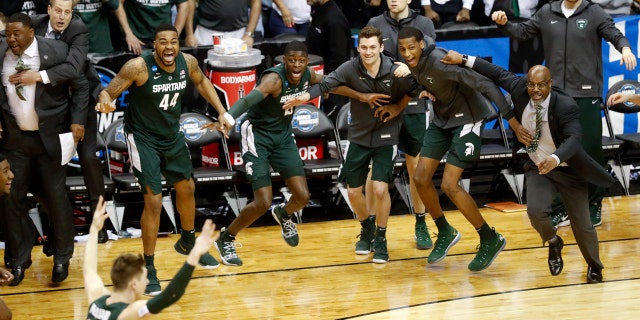 Michigan State players begin to celebrate their win over Duke at the end of the NCAA men's East Regional final college basketball game in Washington, Sunday, March 31, 2019. (AP Photo}