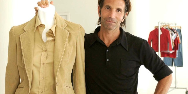 This May 15, 2002 file photo shows Los-Angeles based clothing designer Mossimo Giannulli posing with his fall preview clothing for Target department stores in New York. Giannulli and his wife, actress Lori Loughlin were charged along with nearly 50 other people Tuesday in a scheme in which wealthy parents bribed college coaches and other insiders to get their children into some of the most elite schools in the country, federal prosecutors said.