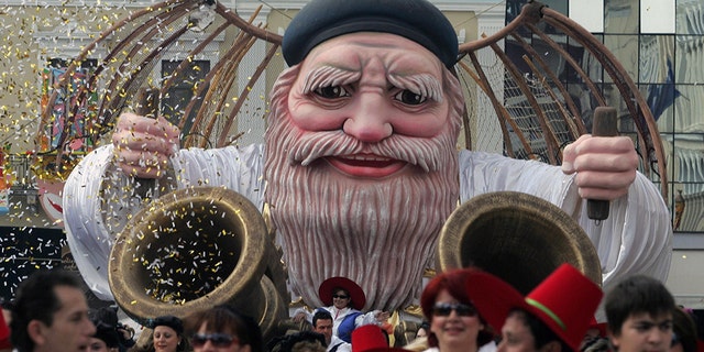 Patras, GREECE: Participants of the most famous Greek carnival in the city of Patras, parade in the streets to mark the last day of the carnival 05 March 2006. Thousands of visitors arrived to take part in the celebrations in the city of Patras, which is the European Capital of Culture for the year 2006. AFP PHOTO/Louisa Gouliamaki (Photo credit should read LOUISA GOULIAMAKI/AFP/Getty Images)