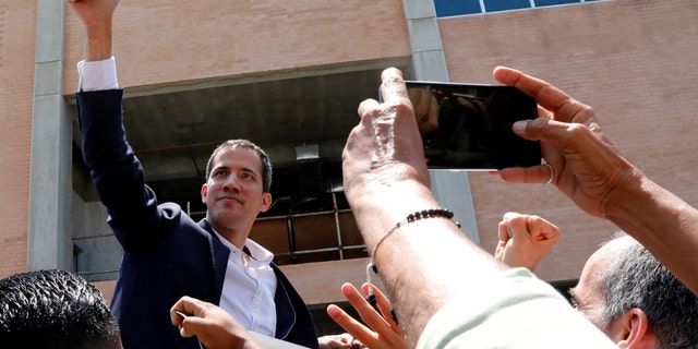 Venezuelan opposition leader Juan Guaido, who many nations have recognized as the country's rightful interim ruler, greets supporters after his arrival at the Simon Bolivar International airport in Caracas, Venezuela March 4, 2019. REUTERS/Carlos Jasso - RC1427AEED70
