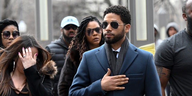 Empire actor Jussie Smollett, center, arrives at the Leighton Criminal Court Building for his hearing on Thursday, March 14, 2019, in Chicago. (AP Photo/Matt Marton)