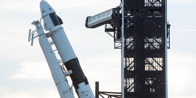 A SpaceX Falcon 9 rocket with the company's Crew Dragon spacecraft onboard is seen as it is raised into a vertical position on the launch pad at Launch Complex 39A as preparations continue for the Demo-1 mission, Thursday, Feb. 28, 2019.