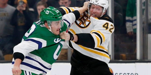 Carolina Hurricanes left wing Micheal Ferland and Boston Bruins right wing David Backes fight during the first period of an NHL hockey game, on Tuesday, March 5, 2019.