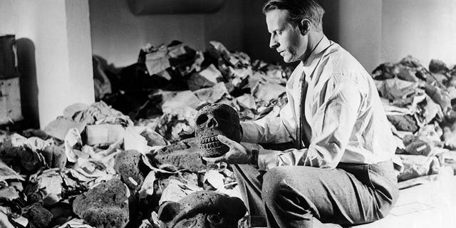 Norwegian anthropologist and explorer Thor Heyerdahl photographed with archaeological artifacts from Easter Island, 1957.