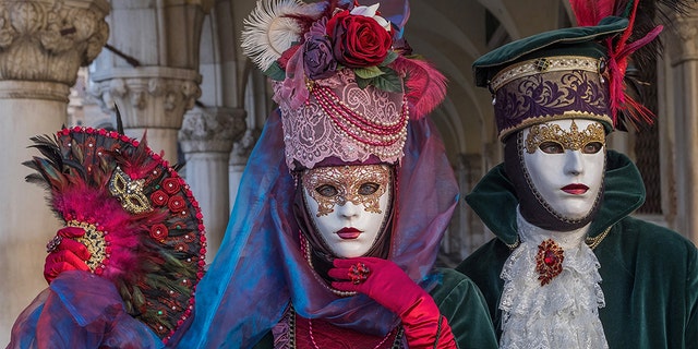 VENICE, ITALY - FEBRUARY 04: People wearing carnival costumes pose in St. Mark square during the Flight of Angel on February 4, 2018 in Venice, Italy. The theme for the 2018 edition of Venice Carnival is 'Playing' and will run from 27 January to 13 February. (Photo by Awakening/Getty Images)