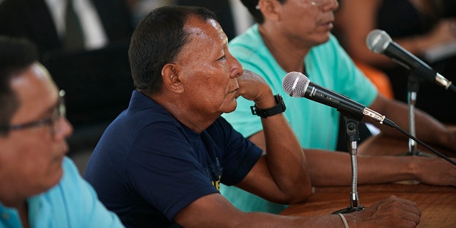 Bare Bornaldo Waimiri sits before a microphone as he gives testimony about alleged crimes committed by the Brazilian dictatorship in the 1970s during a hearing on the Waimiri-Atroari reserve in Brazil's Amazon state, Wednesday, Feb. 27, 2019. “I lost my father, my mother, my sister and my brother,” Bornaldo said. (AP Photo/Victor R. Caivano)