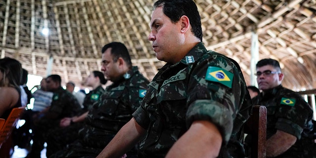 Military officers listen to the testimony of Temehe Tomas Waimiri about alleged crimes committed by Brazil's dictatorship in the 1970s during a hearing on the Waimiri-Atroari reserve, in Brazil's Amazon state, Wednesday, Feb. 27, 2019. Now elderly, indigenous men described horrific scenes that put a spotlight on Brazil’s military, which denies attacking the tribe. (AP Photo/Victor R. Caivano)