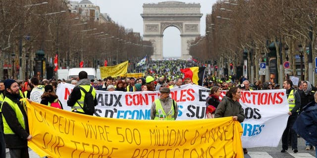 Yellow Vest protesters gather at the Arc de Triomphe in Paris, Saturday, March 9, 2019. French Yellow Vests protested for a 17th straight weekend in Paris and other cities against the government's economic policies they see as favoring the rich.