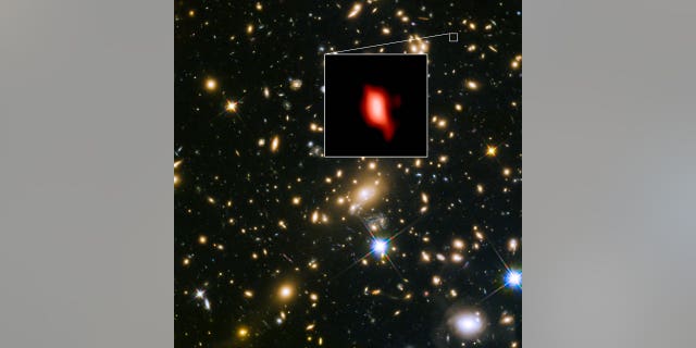 The distant galaxy MACS1149-JD1, shown in the insert, appears as it was 13.3 billion years ago, only 500 million years after the Big Bang. Oxygen distribution detected by ALMA appears in red.