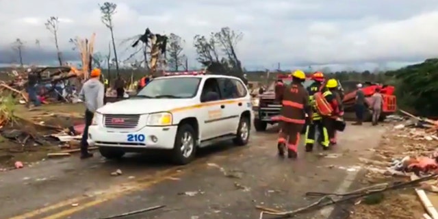 Emergency responders work in the scene amid debris in Lee County, Ala., after a tornado struck in the area Sunday, March 3, 2019.