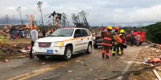 Emergency responders work in the scene amid debris in Lee County, Ala., after a tornado struck in the area Sunday, March 3, 2019.