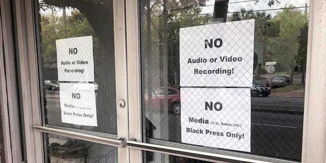 In this Wednesday, March 27, 2019 photo, signs posted on the doors of the Bolten Street Baptist Church are seen during a meeting coordinated to garner support for one black candidate in Savannah's mayoral race, in Savannah, Ga. Organizers of a meeting to discuss an upcoming mayoral race in Georgia barred reporters from attending, unless they were African-American. (Eric Curl/Savannah Morning News via AP)