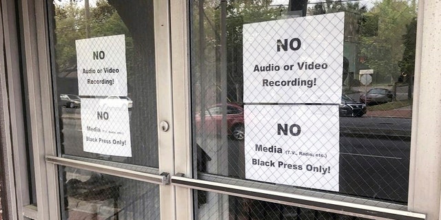 In this Wednesday, March 27, 2019 photo, signs posted on the doors of the Bolten Street Baptist Church are seen during a meeting coordinated to garner support for one black candidate in Savannah's mayoral race, in Savannah, Ga. Organizers of a meeting to discuss an upcoming mayoral race in Georgia barred reporters from attending, unless they were African-American. (Eric Curl/Savannah Morning News via AP)