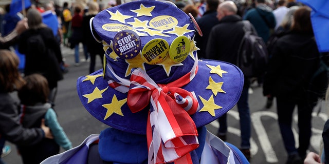 A demonstrator wears a hat decorated with the EU and British colors during a Peoples Vote anti-Brexit march in London, Saturday.