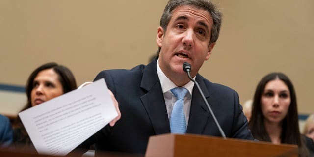 FILE - In this Wednesday, Feb. 27, 2019 file photo, Michael Cohen, President Donald Trump's former personal lawyer, reads an opening statement as he testifies before the House Oversight and Reform Committee on Capitol Hill in Washington. Cohen says he's cooperating with federal prosecutors in New York and hopes to receive a so-called Rule 35 motion from prosecutors that would reduce the time he is to spend in prison. (AP Photo/J. Scott Applewhite, File)