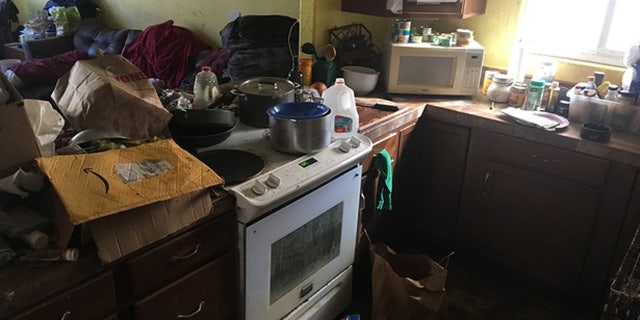"Excessive animal fecal and urine matter" throughout the entire home, in addition to floors and countertops piled with trash.